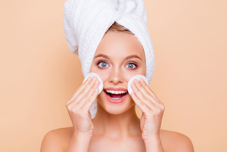 Woman using a facial toner after bathing