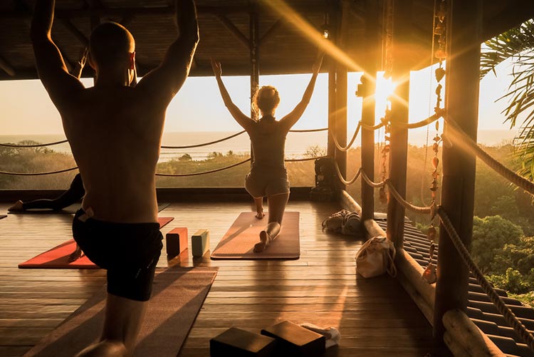People doing yoga at sunrise