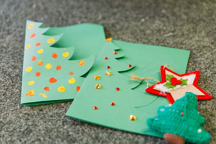 Green Christmas card with a star and Christmas tree ornament