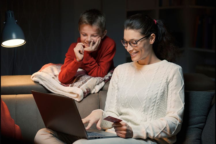 Mother and son looking at the laptop and smiling