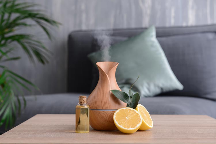 Aroma diffuser with essential oil and lemon next to it