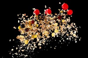 Oats and berries against a dark background