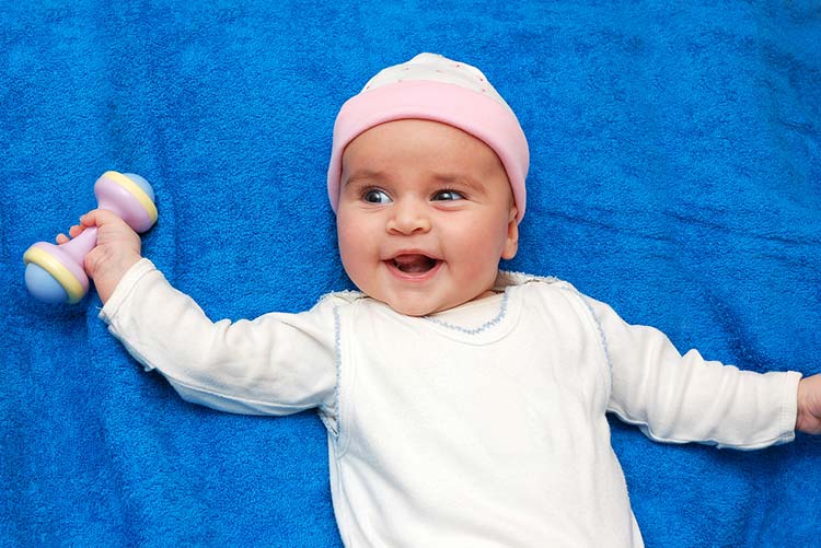 Baby holding a dumbbell