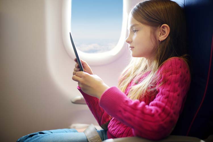 Girl watching something on her ipad in the flight