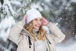 Young woman’s portrait standing in the snow.