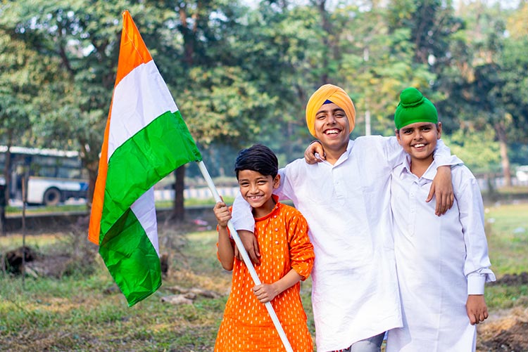 Three boys gleefully dressed in ethnic colours for Republic Day - representing three different religions.