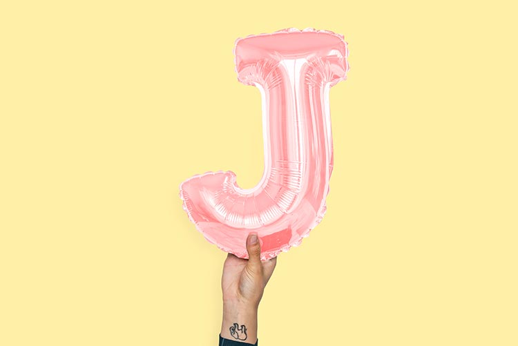 The letter J balloon held up.