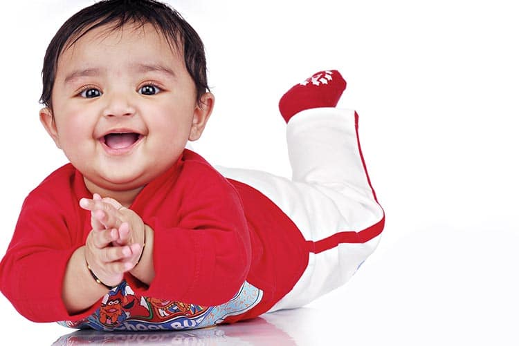 An infant boy playing.