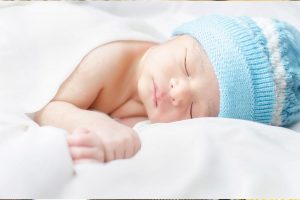 A newborn baby fast asleep.