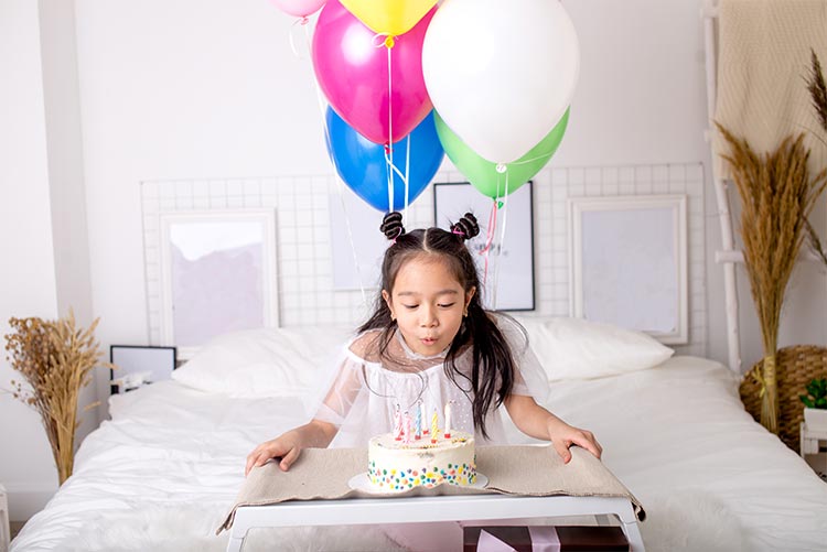 A girl making a wish on her birthday.