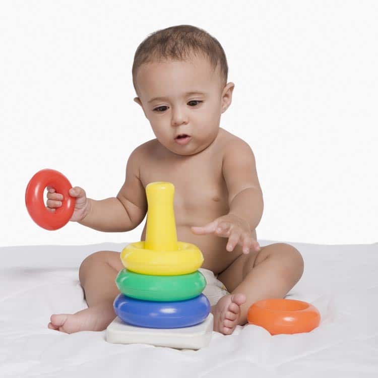 Cute toddler playing with his toys.