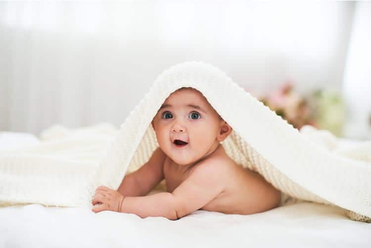 Adorable infant wrapped in a towel.