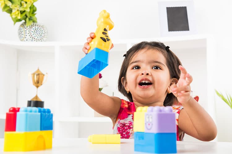 Adorable Indian baby girl playing with block toys!