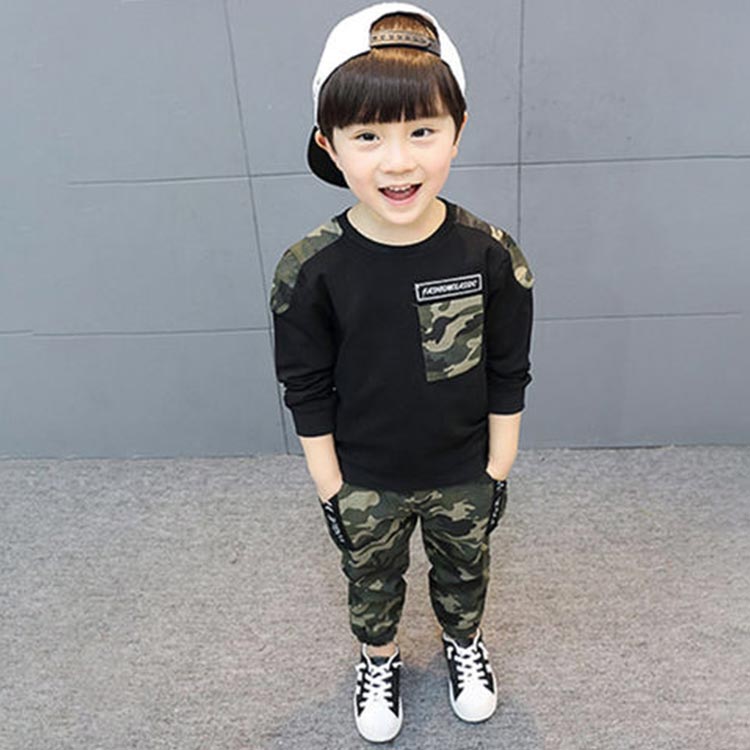 Adorable young boy in camouflage pants and tshirt!