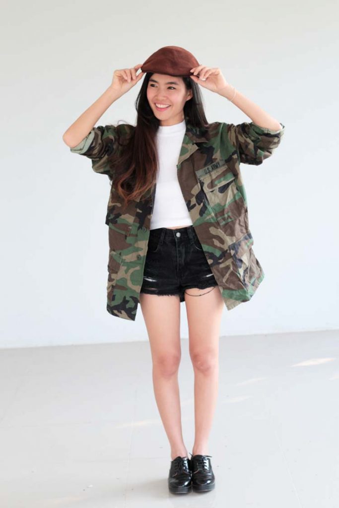 Young woman wearing a Camouflage jacket.
