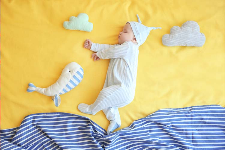 Baby sleeping near the pillow-shaped clouds