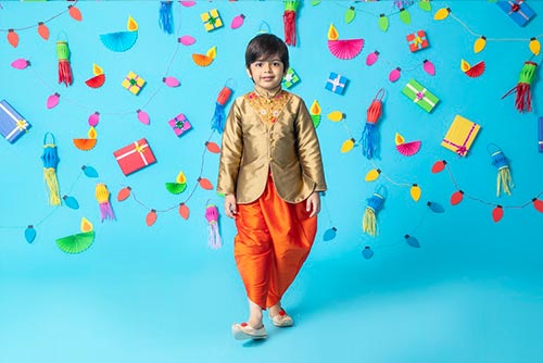 A boy wearing a silk kurta and dhoti set