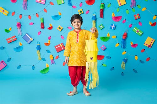 A boy wearing a bandhani kurta and plain dhoti.