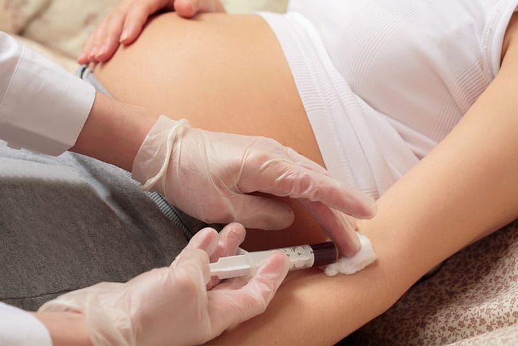 Pregnant woman undergoing a blood test done