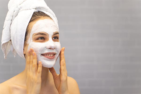 A lady applying a face pack.