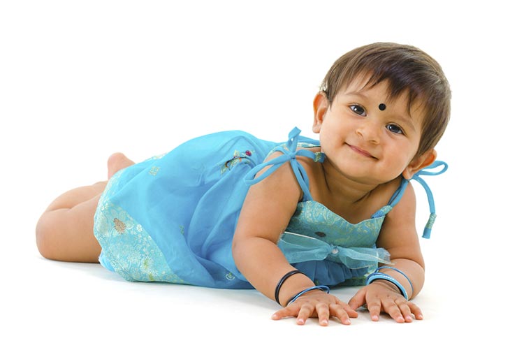 Little girl lying down, smiling at the camera!