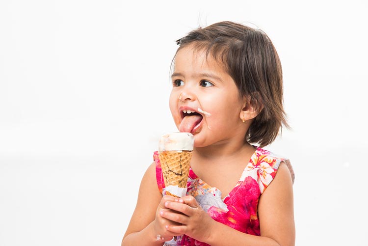 Happy toddler licking an ice-cream!