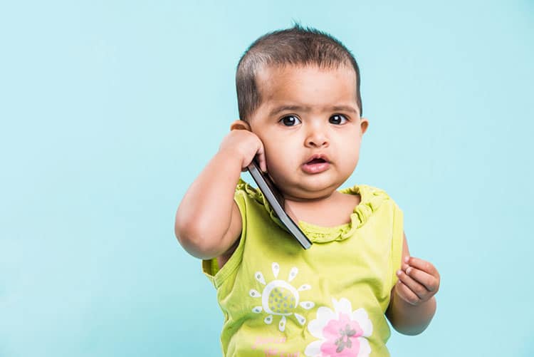 Adorable toddler talking on a smartphone!