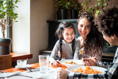 A family of three having dinner.