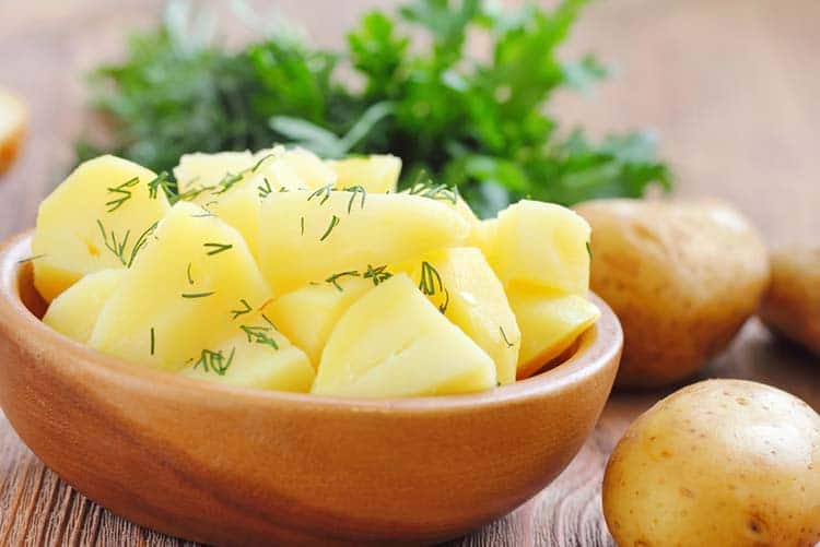 Boiled potatoes topped with fresh cilantro.