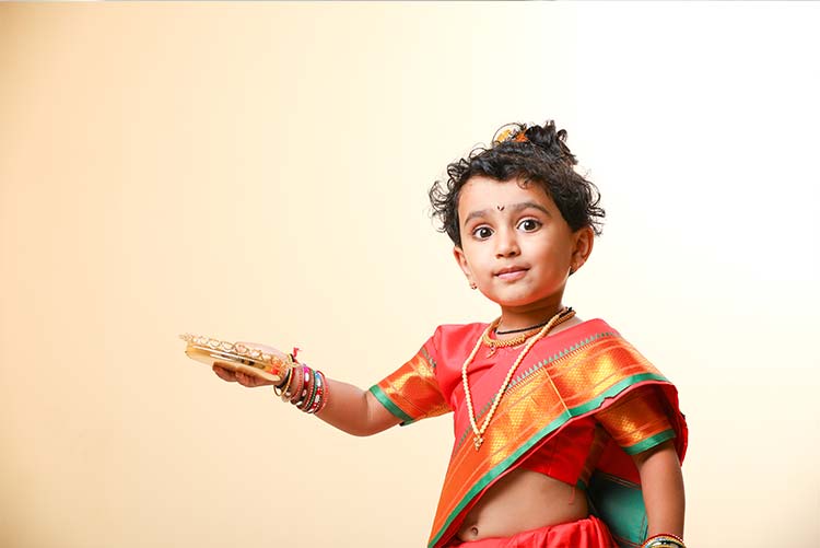 A young girl dressed in ethnic clothes.