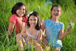 Three siblings enjoying a day at the park.