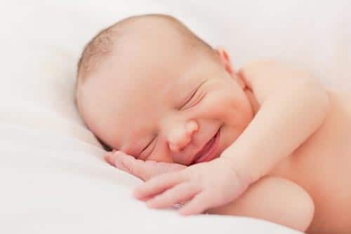 Newborn baby smiling.