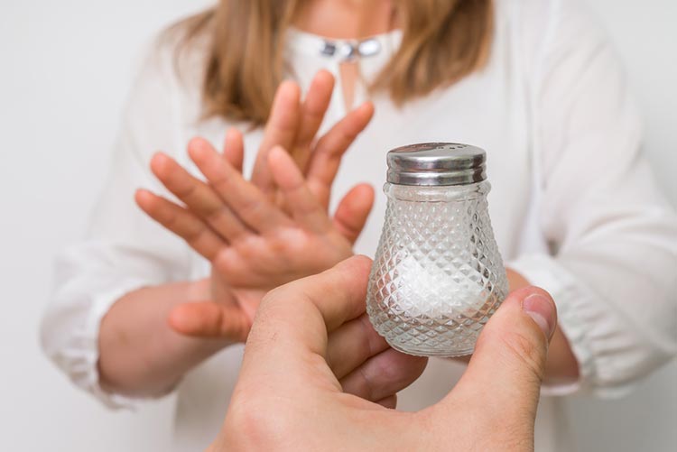 Woman refusing a bottle of salt