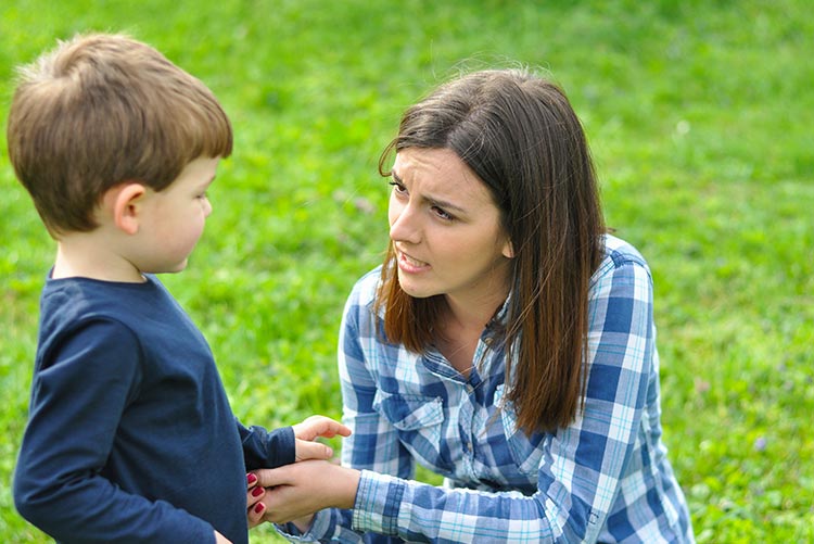 A mother talking to her child patiently.