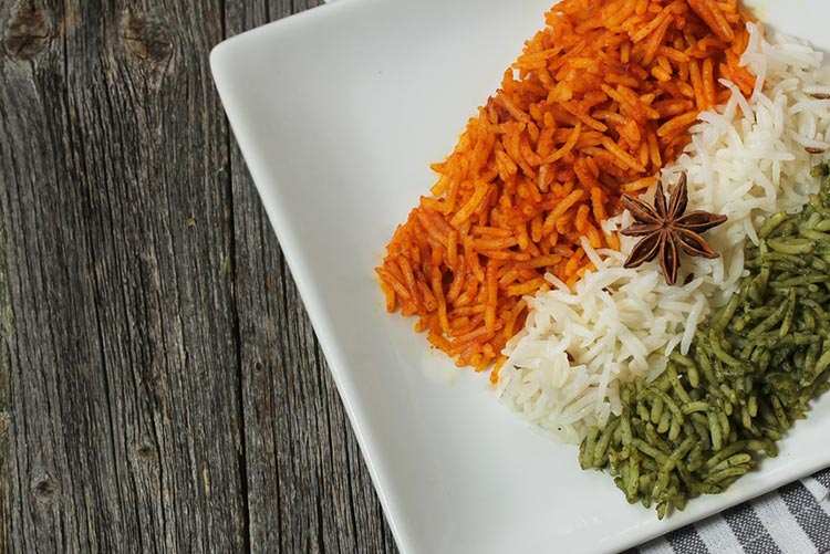 Tricolour rice served on a white dish.