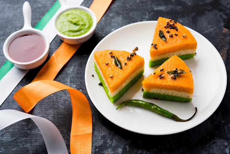 Tricolour dhokla (a Gujarati dish) served with green chutney and tomato ketchup!
