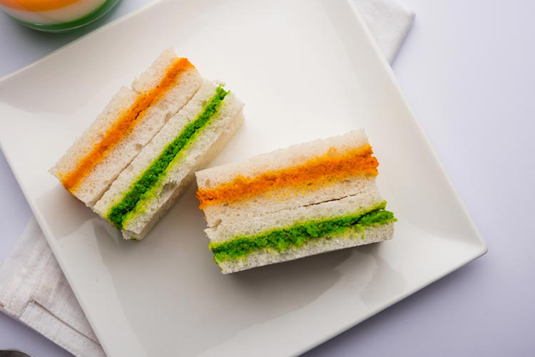 Tricolour sandwich served on a white plate.
