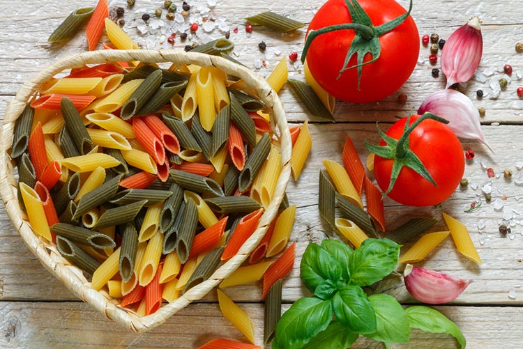 Tricolour penne pasta kept with tomatoes and onions!