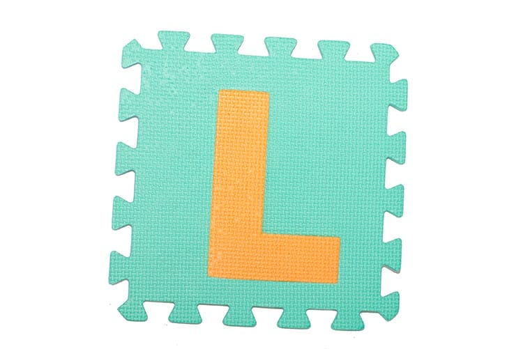 A toy block with the letter L.