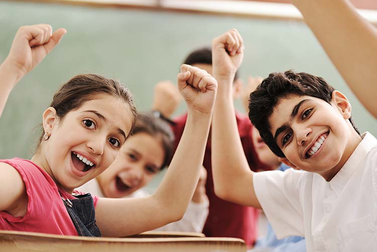 A group of children glad to be in school.