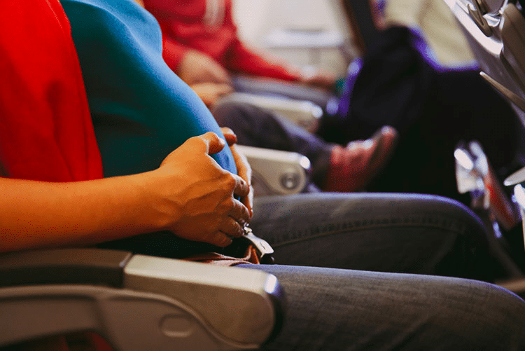 Closeup of a pregnant woman travelling in a flight!