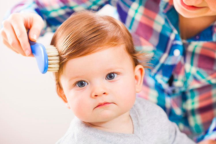 Mother brushing her baby’s hair!