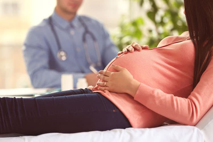 Pregnant woman consulting with the doctor