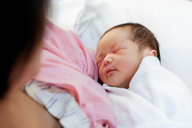 A mother holding her newborn.