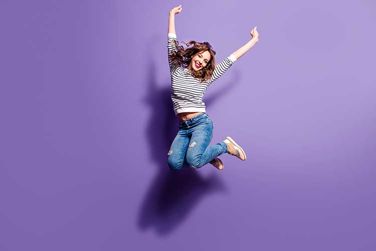 A young girl jumping high.