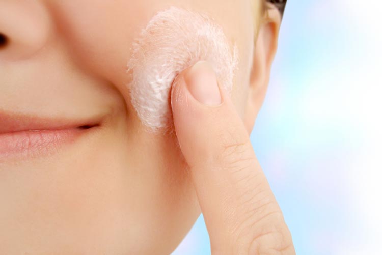 Woman exfoliating skin