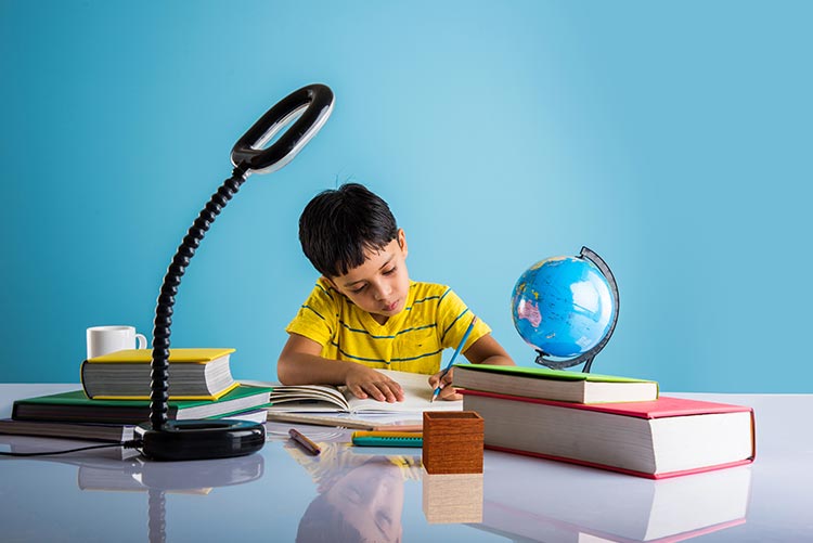 A young boy being homeschooled in India.