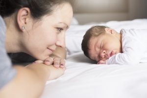 Mother watching sleeping baby