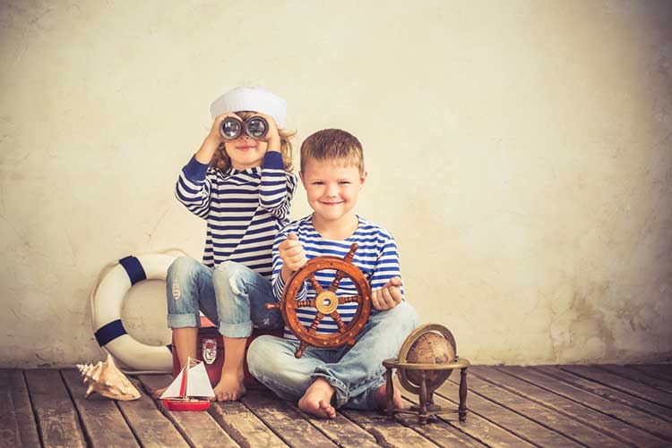 Two kids in Nautical clothing playing 