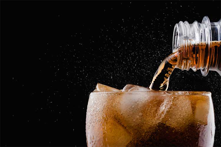 Coca-cola being poured into a glass